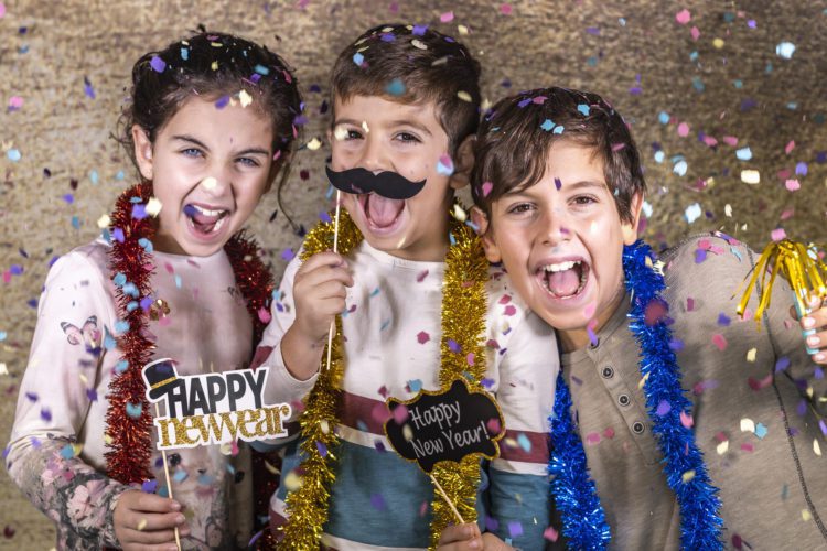 Three happy kids celebrating new year eve